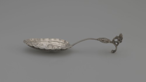 Decorative spoon, oval scoop with a relief pastoral scene framed in a pearled border — a woman sits