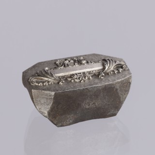 Jewellery die, Approximately hexagonal die with a relief rectangular reserve enclosed at the ends