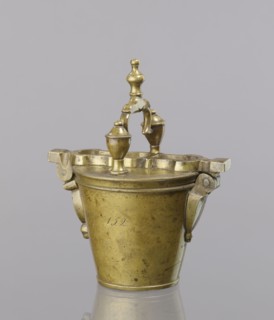 Seven weights in the form of bowls—truncated cones; the eighth largest serves as a container for