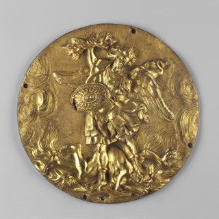 Circular plaque depicting the Archangel Michael with a gilded obverse. The Archangel in half-armor,