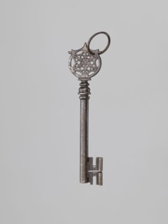 Key, locksmithing, rosette ornament. A Venetian-type key with a smooth tubular shaft, a feather