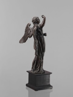 Statue - Angel. Figure of a standing angel with his right hand raised, the other raised to chest