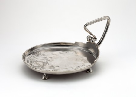 Silver circular plate with a handle on four legs, smooth edge; interior engraved with Art Nouveau