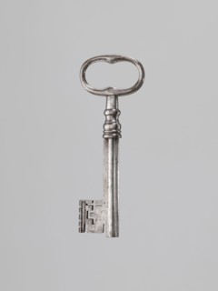Iron key, locksmithing. Key with a tubular club-shaped shaft, with a feather widened at the end.