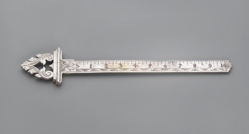 Ruler with a handle composed of interconnected acanthus twigs forming a triangle. Measuring