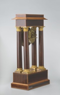 Mantel clock by Alexandre Pertrand fl. ca. 1840. Four-column portico form on a cuboid base and
