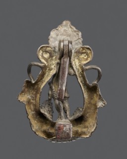 Bronze door knocker with a figure of Bacchus flanked by two lions with raised torsos. Renaissance