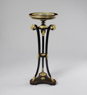 Round table, lacquered black, decorated with gilded cast brass fittings, with a ceramic painted