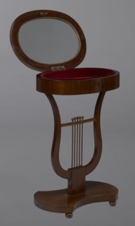 Oval display table with a lyre-shaped base mounted on a platform with a concave–convex outline,