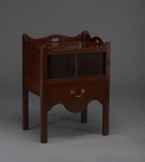 Bedside table with toilet, with a tambour door in the upper section and a pull-out section below