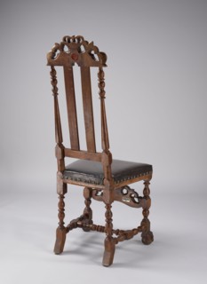 Chair with turned and carved frame elements, padded seat and high backrest, supported by four