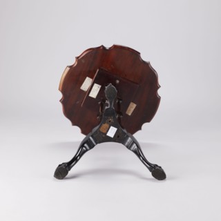 SIDE TABLE with a round top with a wavy, profiled rim, supported by a shaft composed of three
