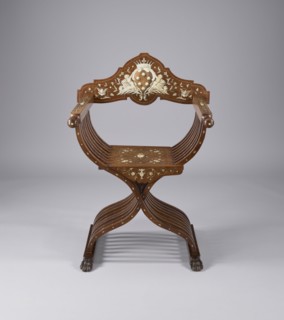 Scissor chair, Scissor armchair made of eight pairs of crossed S-shaped slats, connected at the