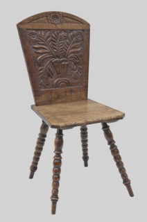 Stool with bas-relief backrest and board seat, on four pearl-turned legs, diagonally inclined.