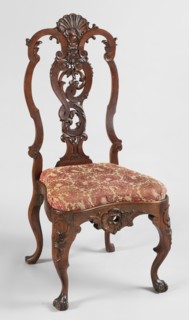 Chair, Carved chair with a padded seat inserted cushion and a high backrest filled by an openwork