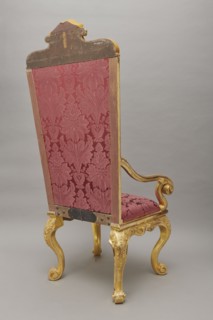 Travel armchair of the late Baroque type, carved and gilded, with a high flat backrest on cabriole