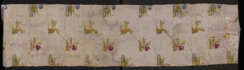 Fragment of pale pink silk fabric brocaded with colorful threads and silver thread. Brocade