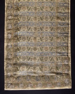 Fragment of a belt with a continuous pattern of alternating silhouetted tendrils with an iris motif
