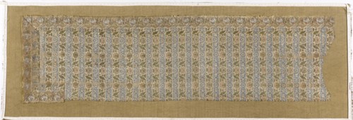 Fragment of a belt with a continuous pattern of alternating silhouetted tendrils with an iris motif