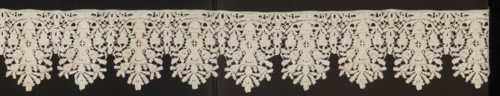 Lace fragment, floral ornaments. Lower edge serrated. In each oval there is a vase of flowers.