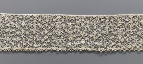 Lace fragment, Lace with a fine floral pattern. de brides background with picots. Lower edge with