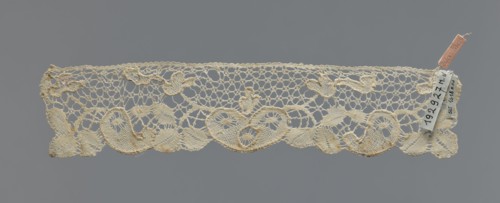 Cuff, repossession provenance; fashion accessory cuff; lace; pattern of leaves and palmettes at the