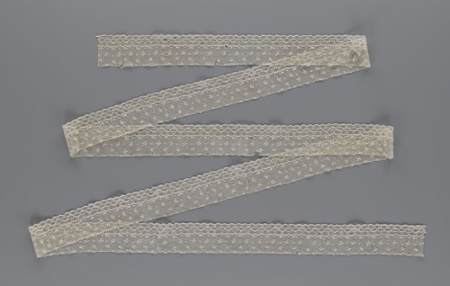 Lace fragment, lace. Edge ornament on one side — a kind of net with numerous loops, small round and