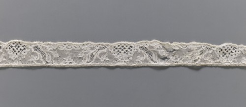 Lace fragment, Floral ornaments. Malines lace. Pattern with motifs of winding ribbons, flowers, and