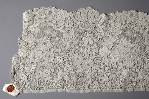 Fragment of Brussels lace; floral ornaments of densely placed roses, leaves, rocaille and