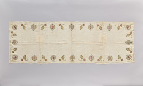 Church napkin made of thin white linen batiste edged with multicoloured embroidery. Ornament