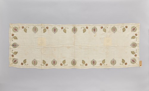 Church napkin made of thin white linen batiste edged with multicoloured embroidery. Ornament