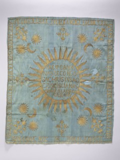 Church napkin. Blue silk rep cloth embroidered with gold thread. In the center, within a radiant