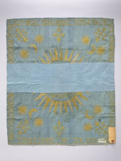 Church napkin. Blue silk rep cloth embroidered with gold thread. In the center, within a radiant