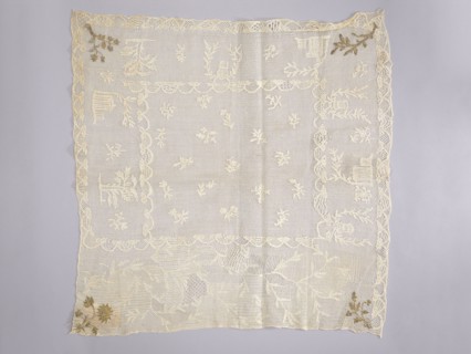 Tablecloth. Embroidered tablecloth; white embroidery on white mesh with gold-thread accents in