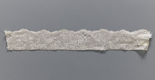 Lace fragment, bobbin lace, white, with a floral tendril ornament on a point de neige background,
