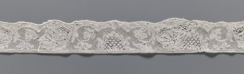 Lace fragment, lace, mesh background with rounded meshes. The lower edge is slightly serrated. The