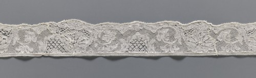Lace fragment, lace, mesh background with rounded meshes. The lower edge is slightly serrated. The