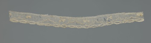 Lace fragment, needle-stitched lace, highly elongated openwork ovals. Above the edge ornament,