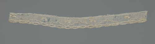Lace fragment, needle-stitched lace, highly elongated openwork ovals. Above the edge ornament,