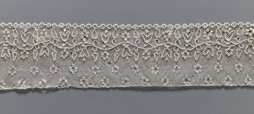 Lace fragment, needle Alençon lace; a flower branch parallel to the edge. Above the branch, in the