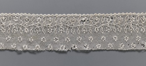 Lace fragment, needle lace Alençon lace, A flower branch parallel to the edge. Above the branch, in