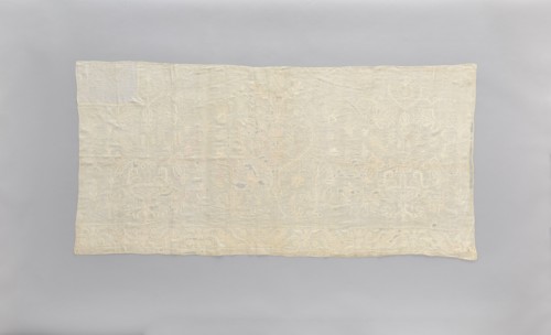 Church napkin made of white linen, covered with white, partially openwork embroidery. In the center