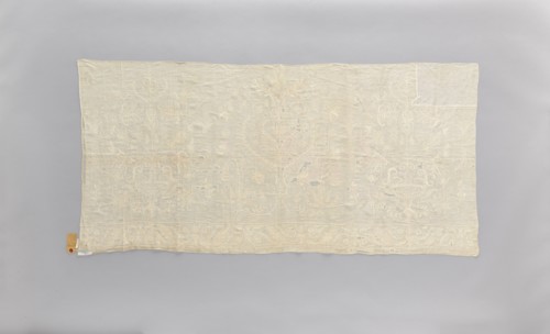 Church napkin made of white linen, covered with white, partially openwork embroidery. In the center