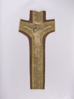 Embroidered Y-shaped chasuble pretext with a depiction of Christ on the cross, surrounded by a