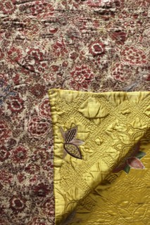 Quilt, Satin quilt, quilted and covered with multicolored embroidery in stylized flower patterns.