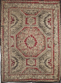 Kilim, In the center a leafy rosette is surrounded by a floral wreath and an octagonal frame.