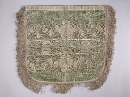 A hood from a church cope. The cope hood is made of pale green velvet. In the center, two