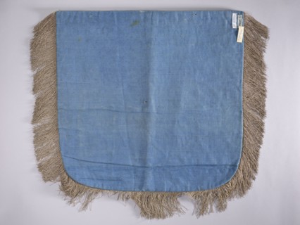A hood from a church cope. The cope hood is made of pale green velvet. In the center, two