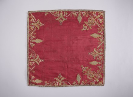 Velum of dark red satin embroidered around the edges with gold and silver thread in motifs of