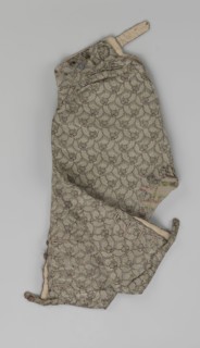 Trousers, short knee-length trousers sewn into a wide belt with a buttoned fly; made of silver lamé